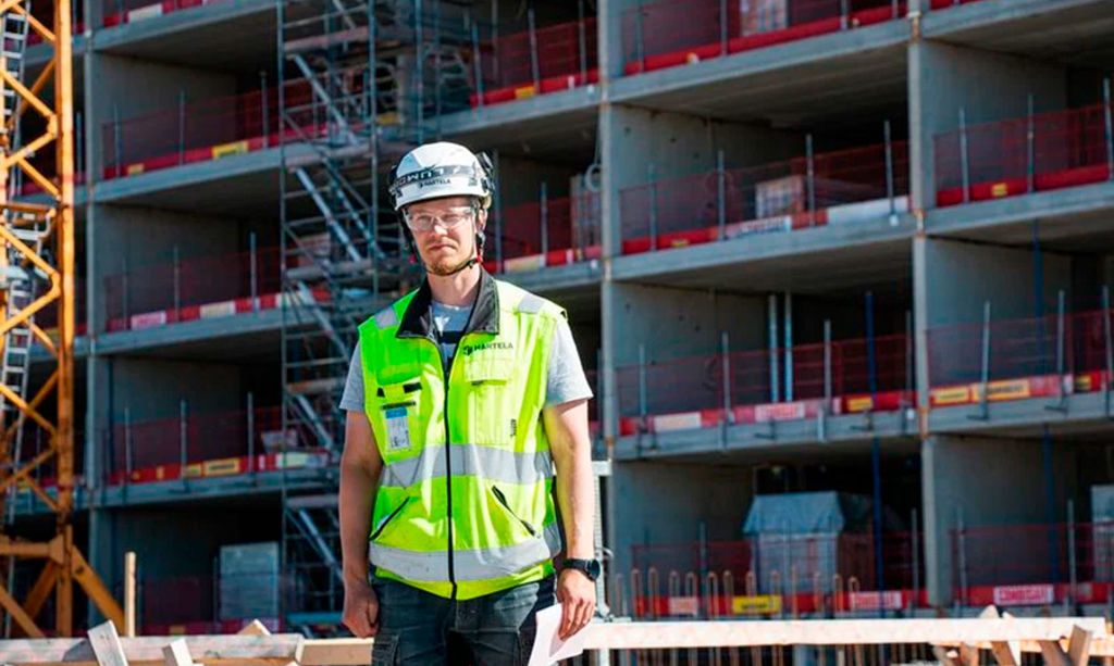 Foreman Juho Peltoniemi stands in front of the Karjasilta Corner under construction.