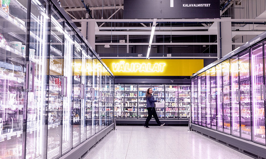A salesperson walks down the aisle carrying a box.