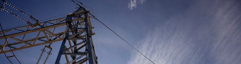 An electric tower pictured from below, sky as a background.
