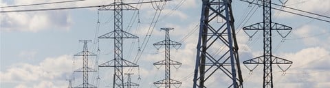 Numerous electricity towers and electricity lines. Sky as a background.