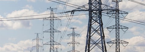 A dozen of electricity towers and electricity lines.