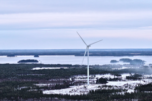 An aerial photograph of a wind turbine in the Lestijärvi wind farm in a winter landscape.