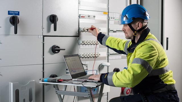 Työvaatteisiin sonnustautunut Oulun Energian työntekijä tekee sähkömittauksia.