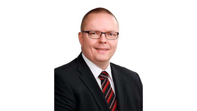 Kimmo Alatulkkila looks into the camera with a smile.