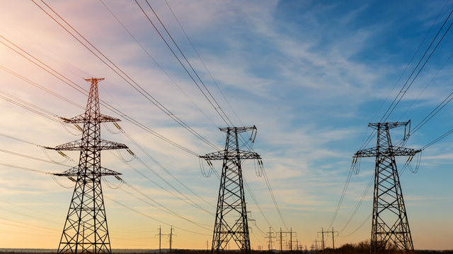 Power lines and blue skies at sunset.