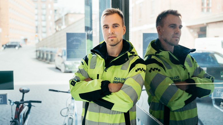 Sami Karjalainen leaning against a glass door.